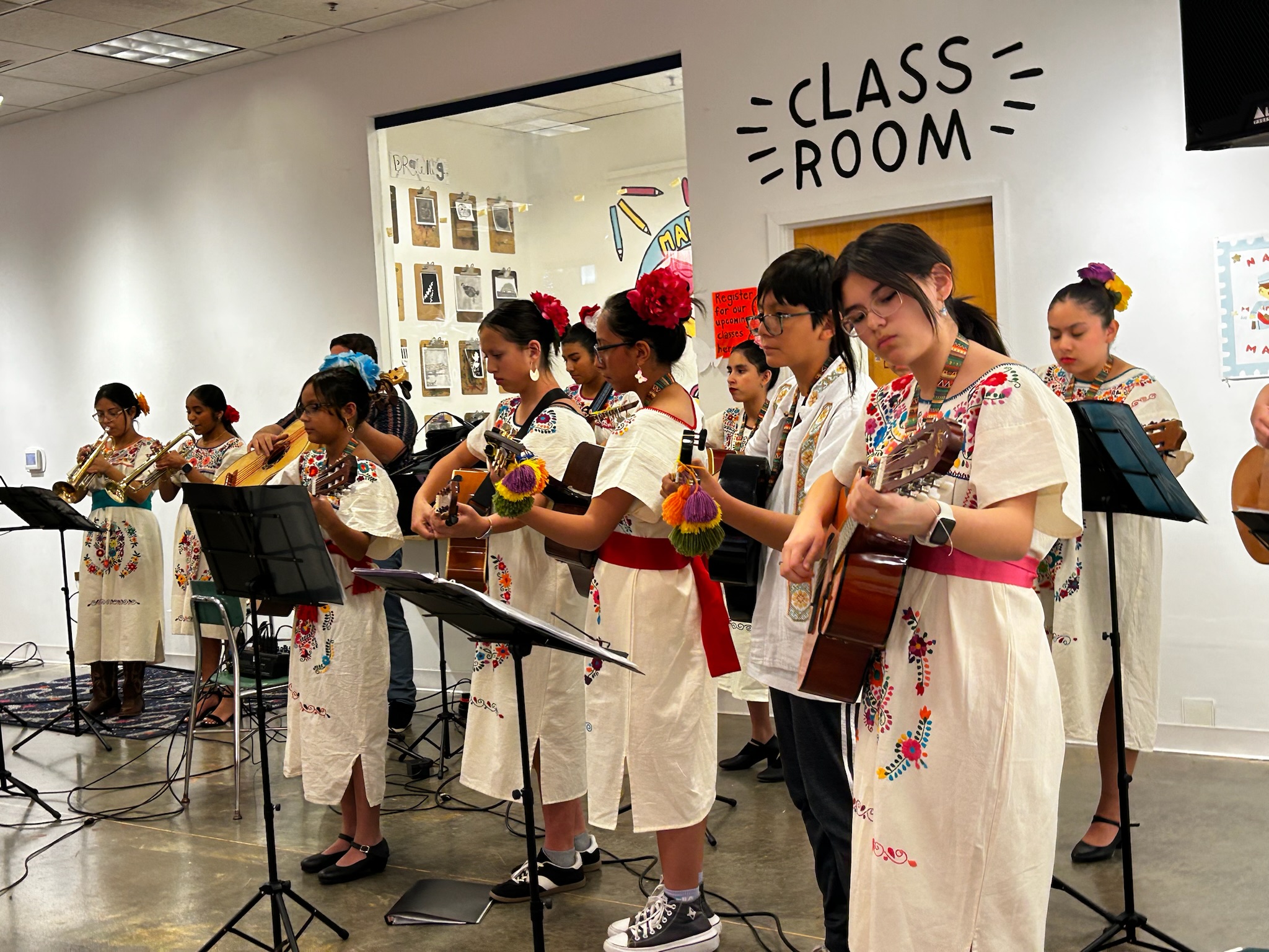 Ella Rises mariachi students rehearsing together in traditional dresses