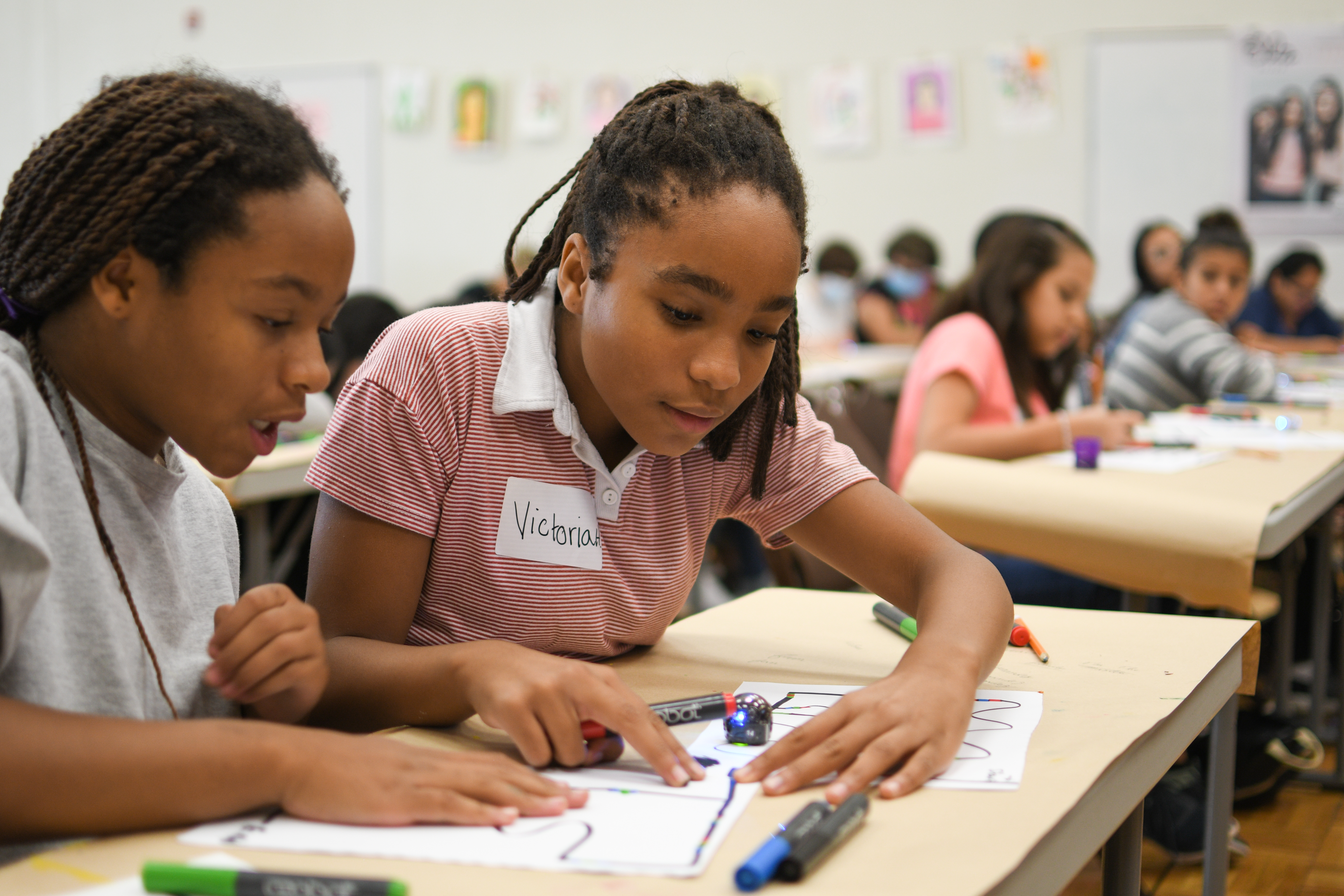 Student focused on a STEAM activity at a classroom table